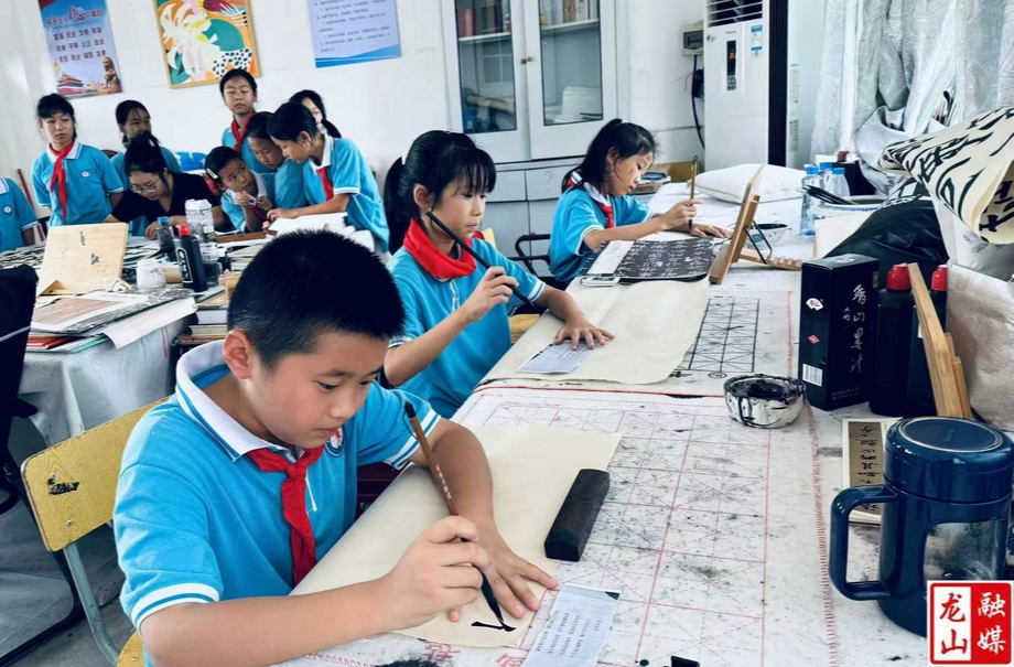 第六小学开展长龙帮扶题材校园书法创作